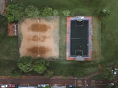 Wide-angle view of the large Dodbalapur main road turf filled with weekend tournament players.