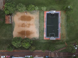 Wide-angle view of the large Dodbalapur main road turf filled with weekend tournament players.