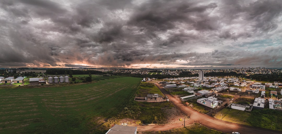 an aerial view of a small town under a cloudy sky,