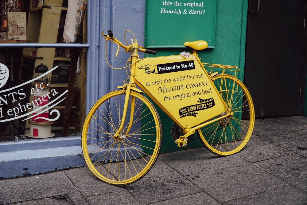 a yellow bicycle parked in front of a store