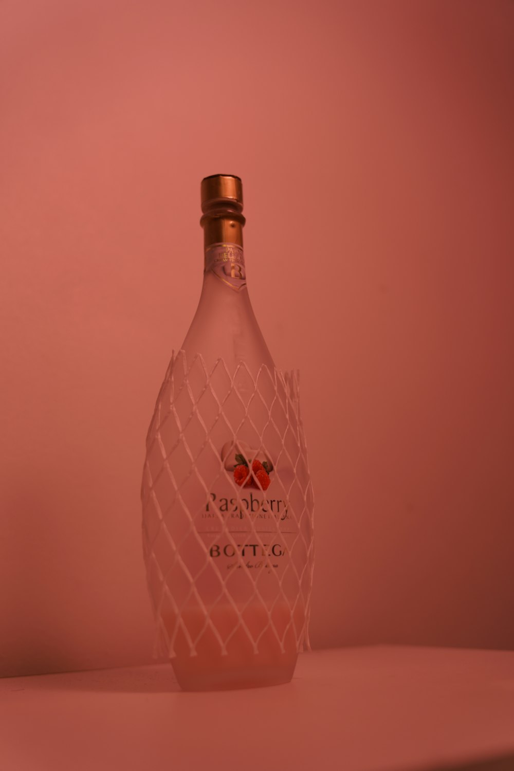 a bottle of pink wine sitting on top of a table