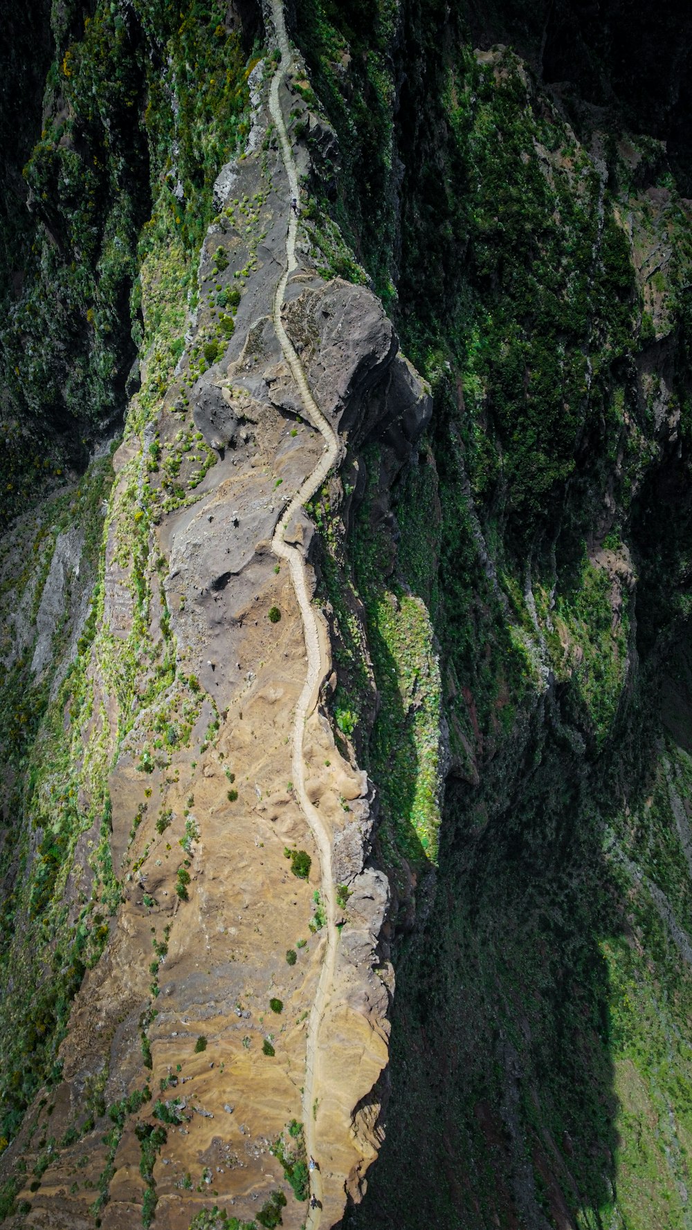 an aerial view of a winding road in the mountains