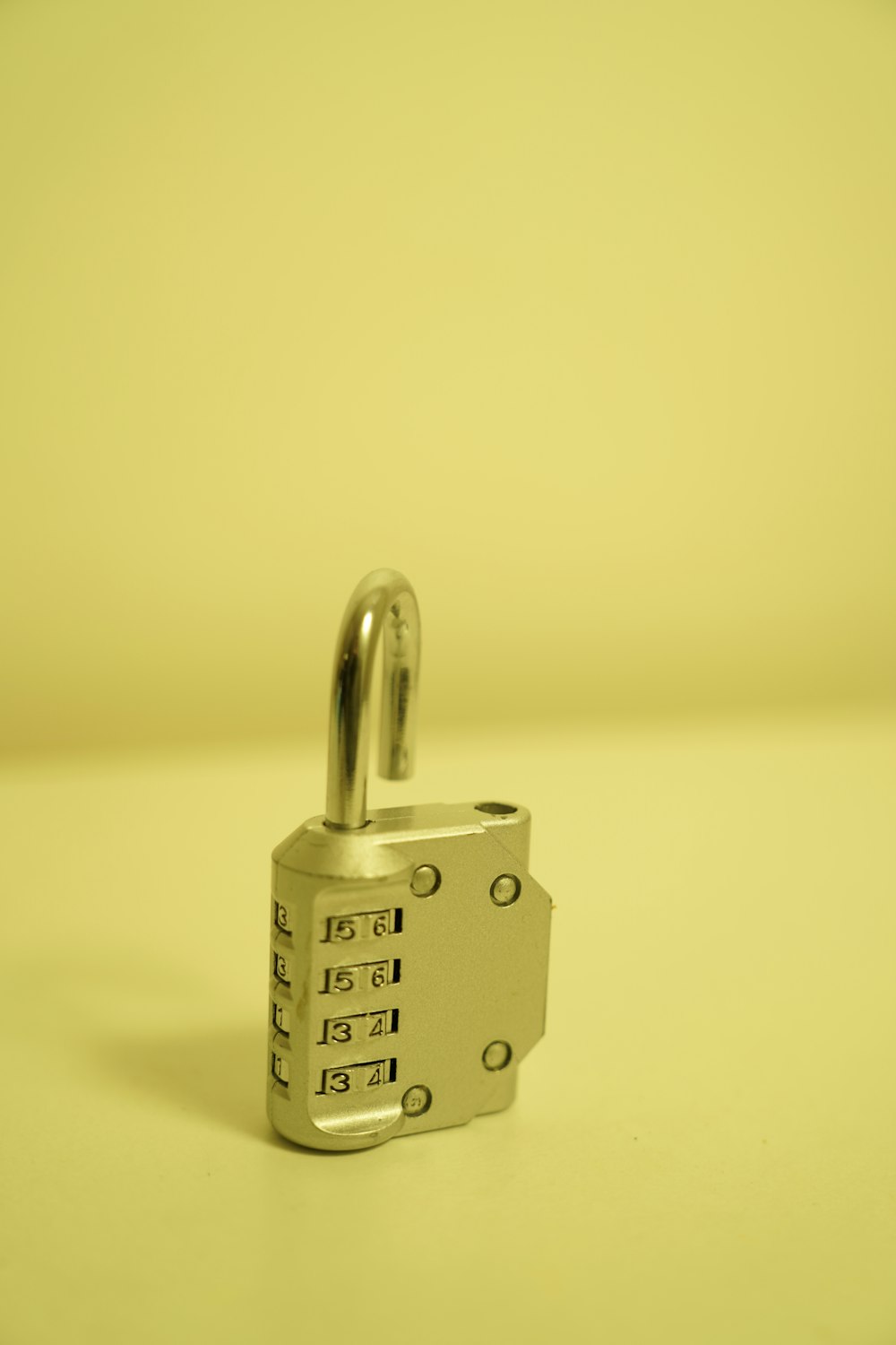 a combination combination lock on a yellow background