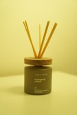 Elegant reed diffuser with wooden sticks emitting soft mist in a cozy natural setting.