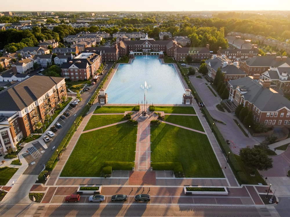 an aerial view of a city with a large pool