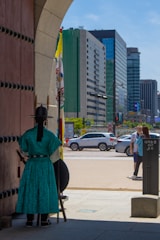 A Roman soldier standing guard at the city gates at sunset.