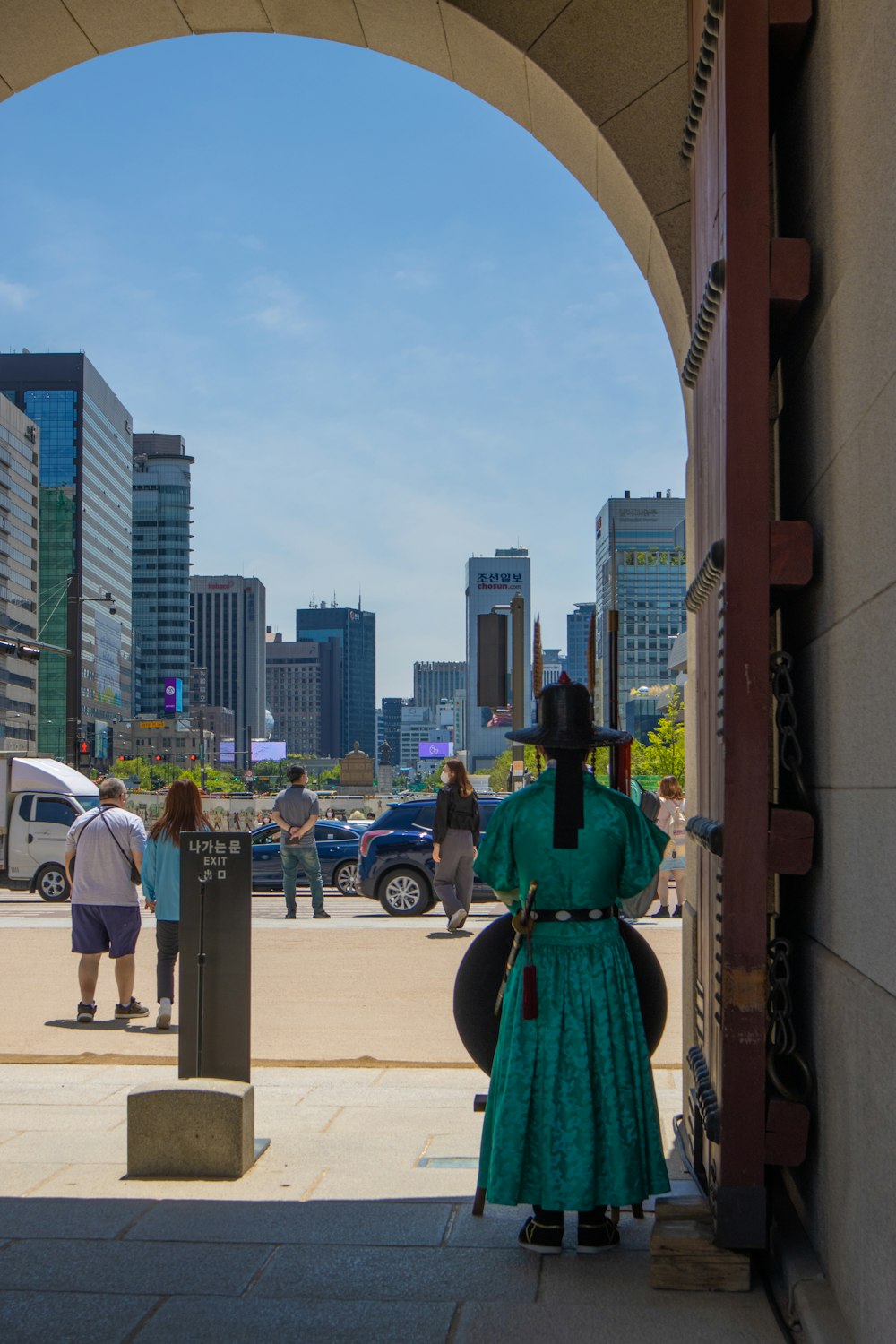 a woman in a green dress standing in a doorway