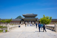 The majestic Gyeongbokgung Palace with mountains in the background during spring.
