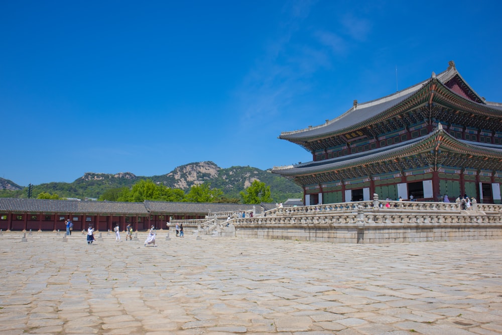 a large building with a lot of people walking around it