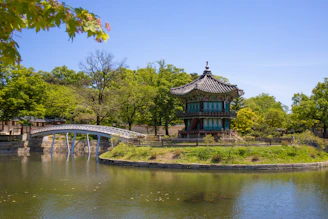 a bridge crossing over a river in a park