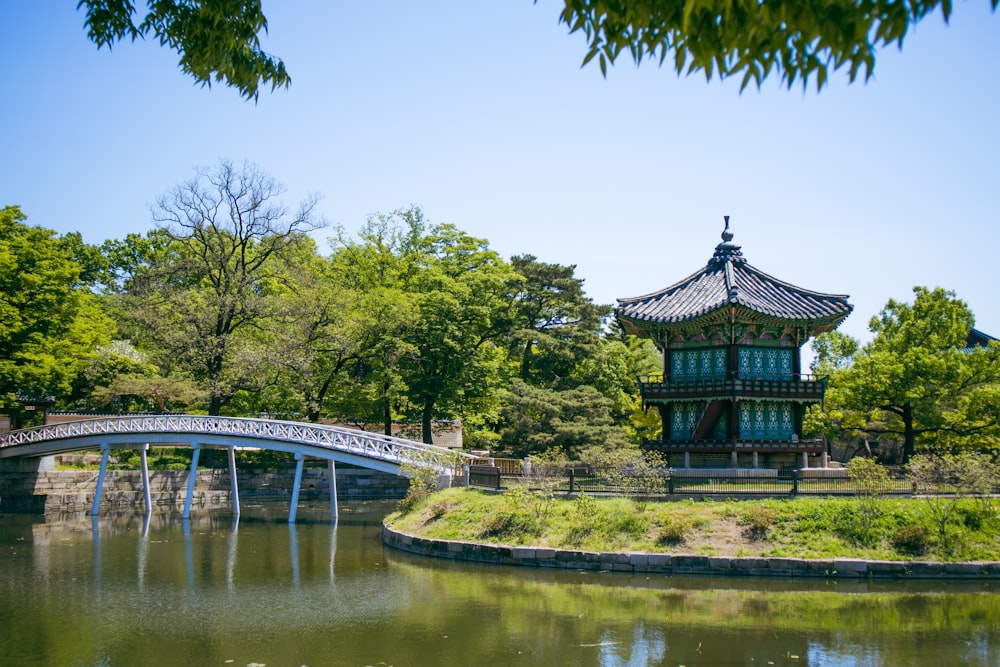 a bridge over a pond in a park