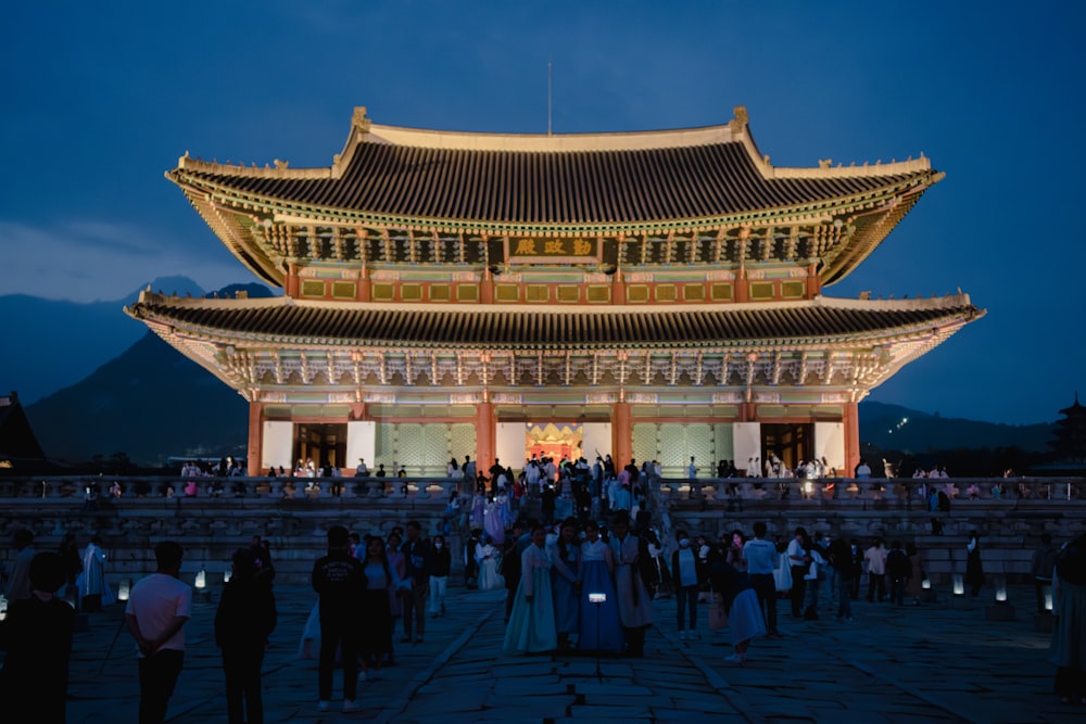 a group of people standing in front of a building