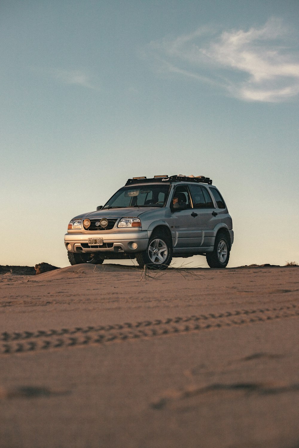 a car parked in the middle of the desert