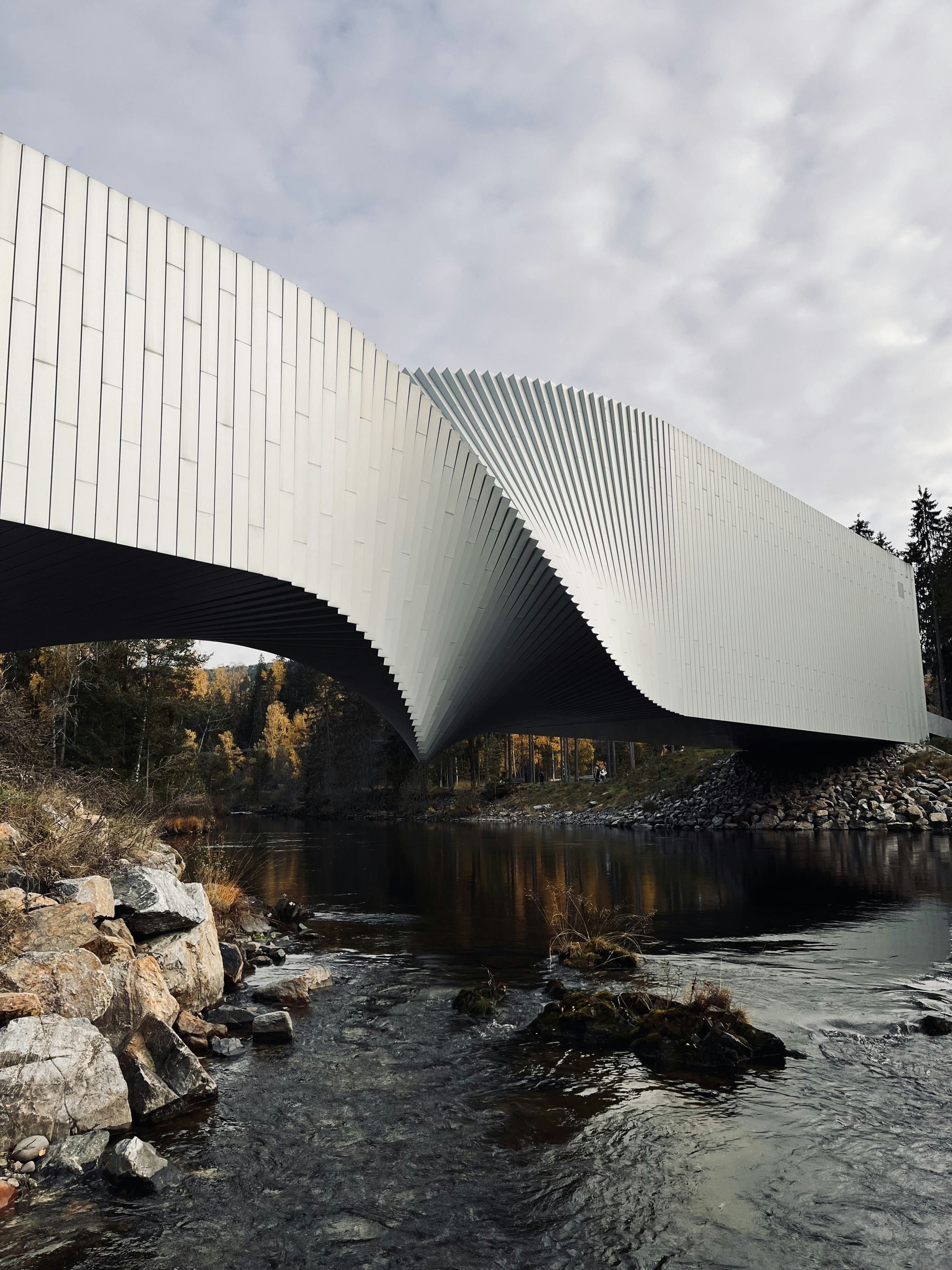 a bridge that is over a river with rocks