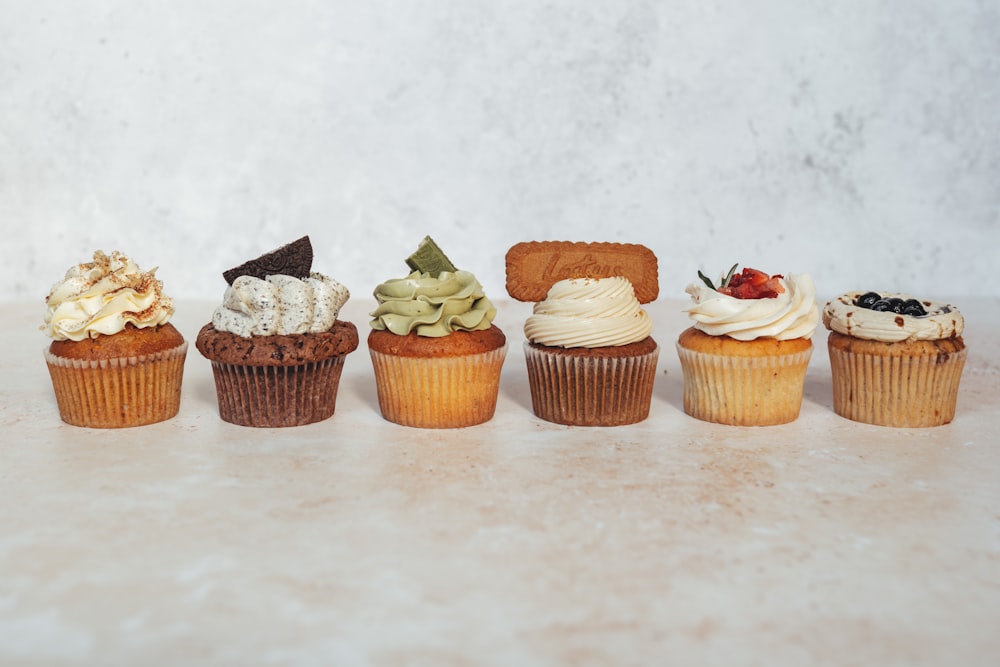 a row of cupcakes sitting on top of a counter