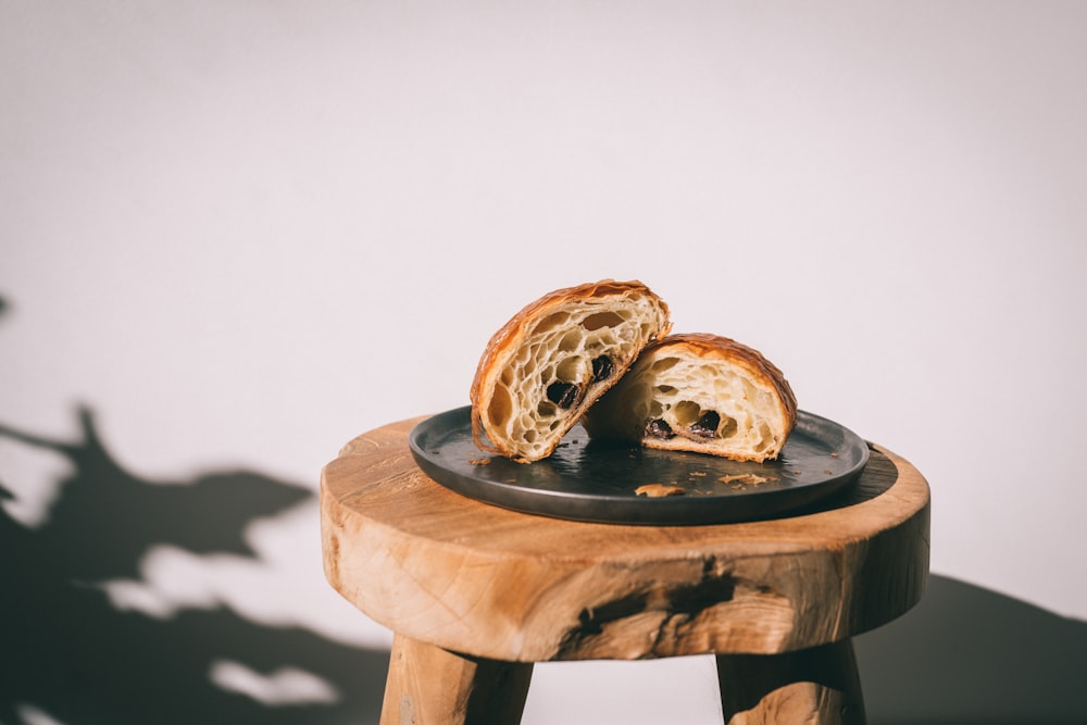 a piece of bread sitting on top of a wooden stool