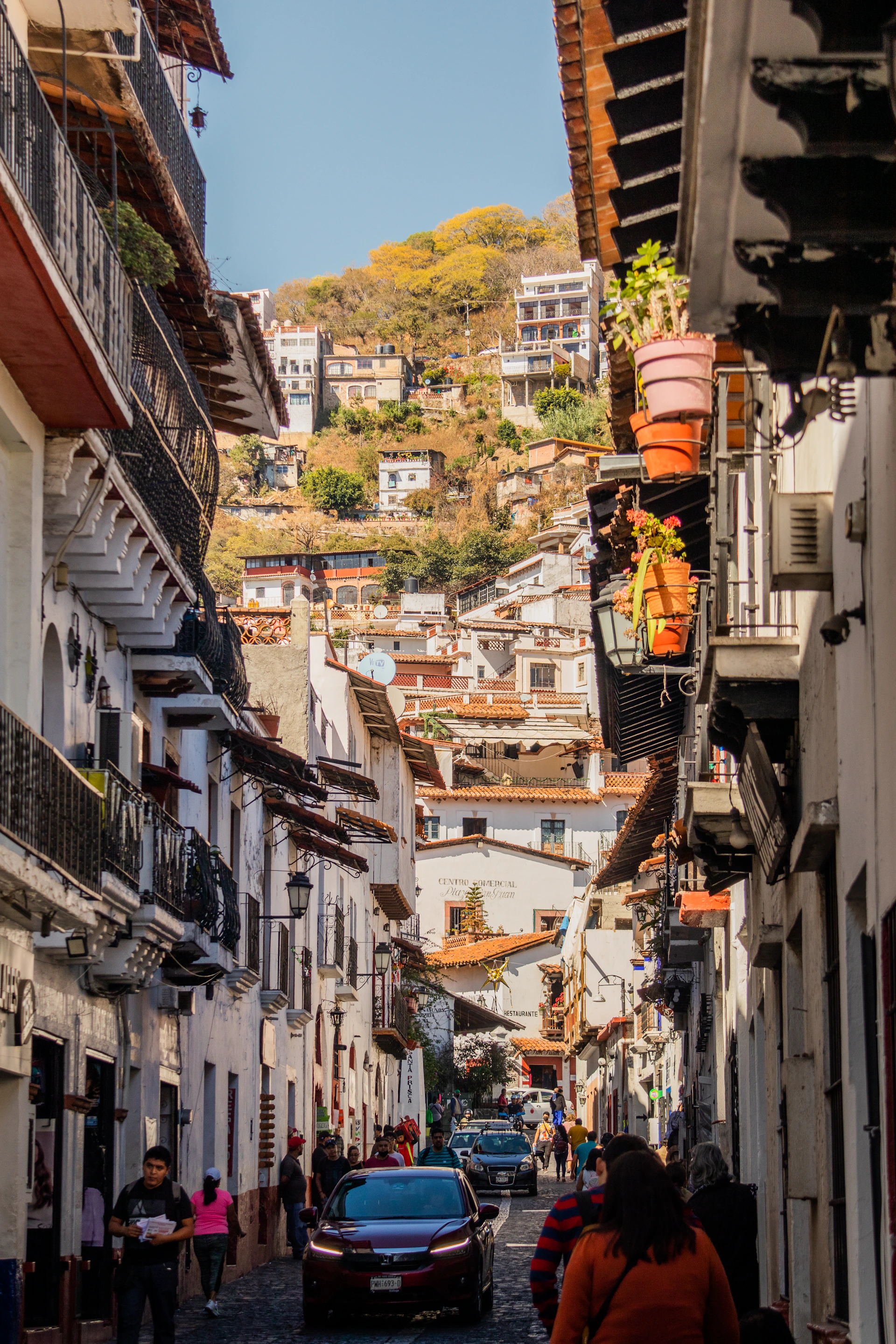 a car is driving down a narrow street