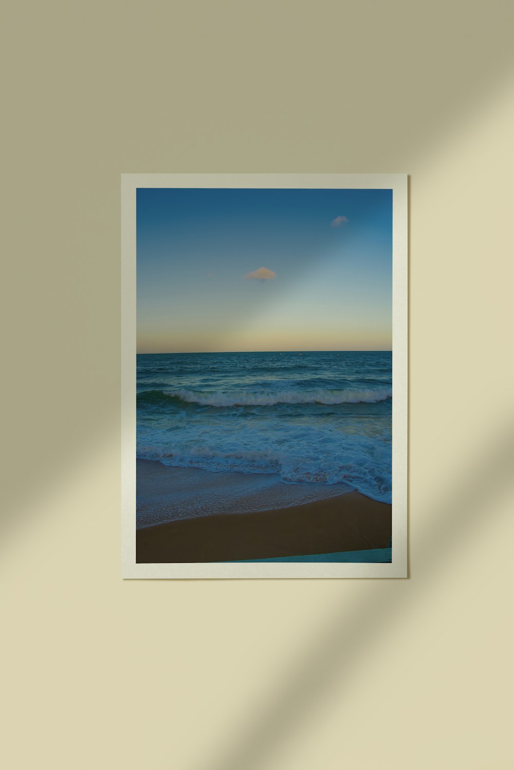 a picture hanging on a wall above a beach