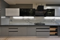 a kitchen with a stove top oven next to a sink
