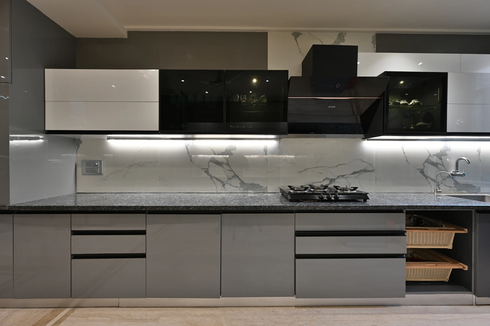 A kitchen with a hob and oven next to a sink