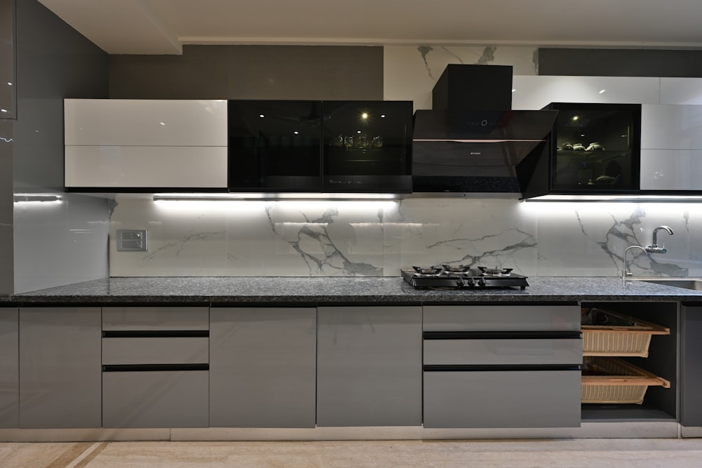 a kitchen with a stove top oven next to a sink