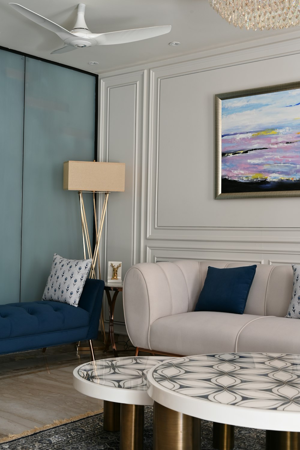 a living room filled with furniture and a painting on the wall