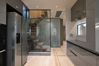 a modern kitchen with a spiral staircase leading to the upper floor