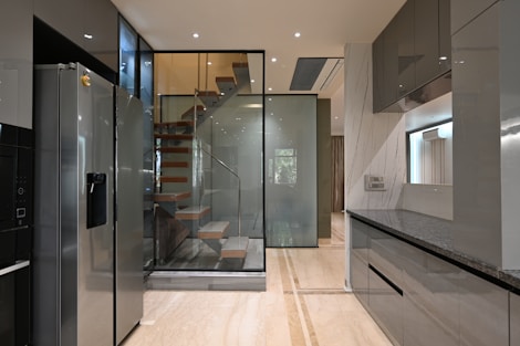 a modern kitchen with a spiral staircase leading to the upper floor