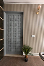 Elegant fiber door with wood-like texture framing a modern bathroom entrance.