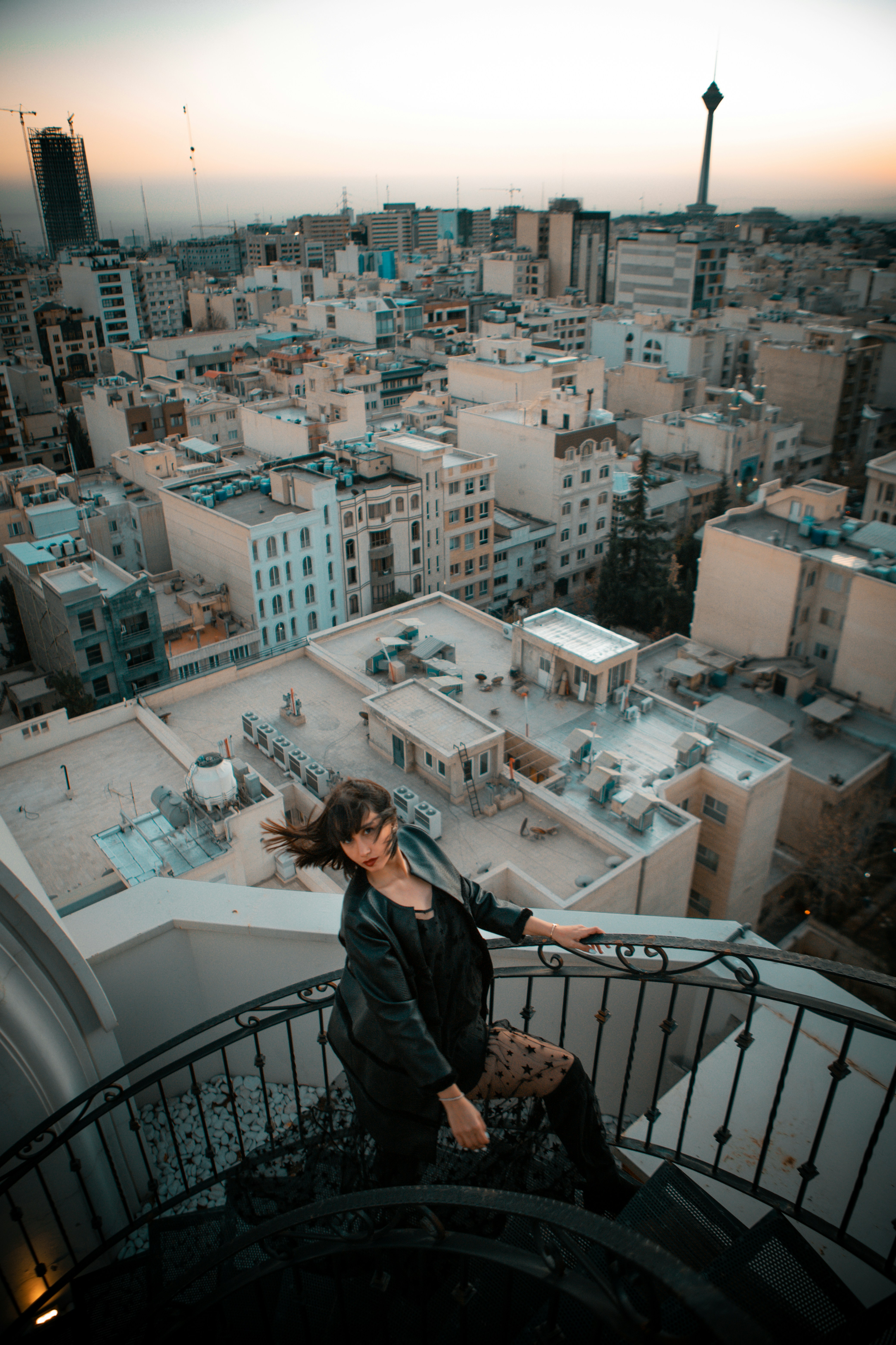 a woman standing on top of a stair case