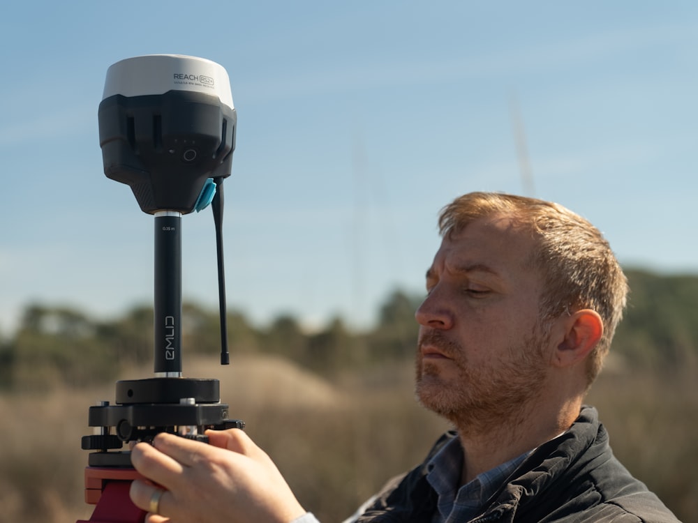 a man holding a camera in front of his face