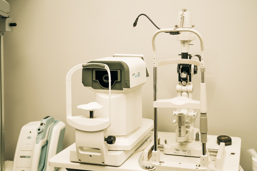 A caring ophthalmologist examining a patient's eyes with advanced equipment in a bright, modern clinic.