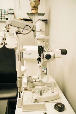 a microscope sitting on top of a table next to a black chair
