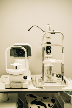 Close-up of a slit lamp with aplanacionim tonometar and electrical lifting table in a clinical setting