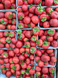 Close-up of fresh fruits arranged neatly in baskets ready for delivery.