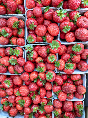 Colorful assortment of berries in small baskets ready for delivery.