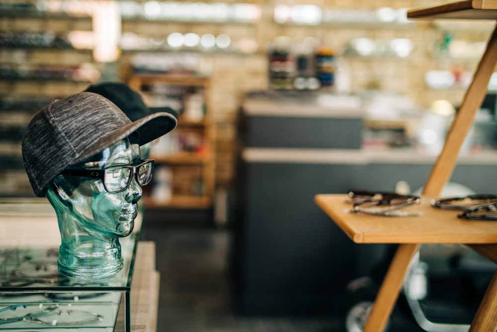 a hat and glasses are on display in a store