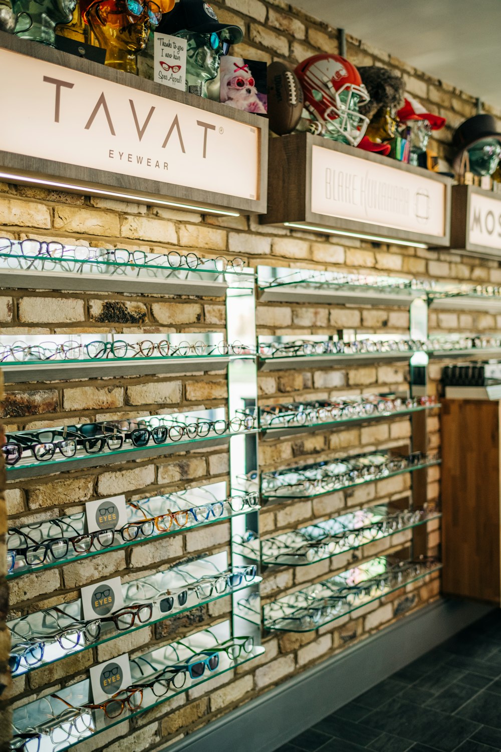 a store with a brick wall and lots of glasses