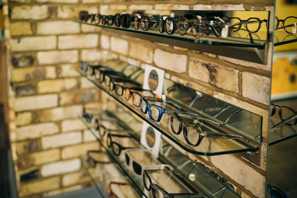 a display of glasses on a brick wall