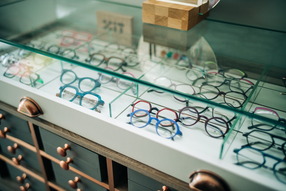 a display case with many pairs of glasses on it