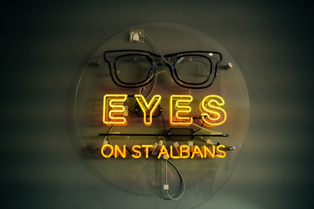 a neon sign with a pair of glasses on it