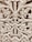 Intricate wooden carving featuring elaborate floral and leaf patterns, with a symmetrical design. The craftsmanship showcases detailed scrollwork and a textured surface.