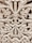 Intricate wooden carving featuring elaborate floral and leaf patterns, with a symmetrical design. The craftsmanship showcases detailed scrollwork and a textured surface.