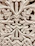 Close-up of a beautifully carved wooden jharokha with intricate floral patterns.