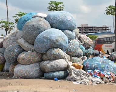 a pile of garbage sitting next to a bus