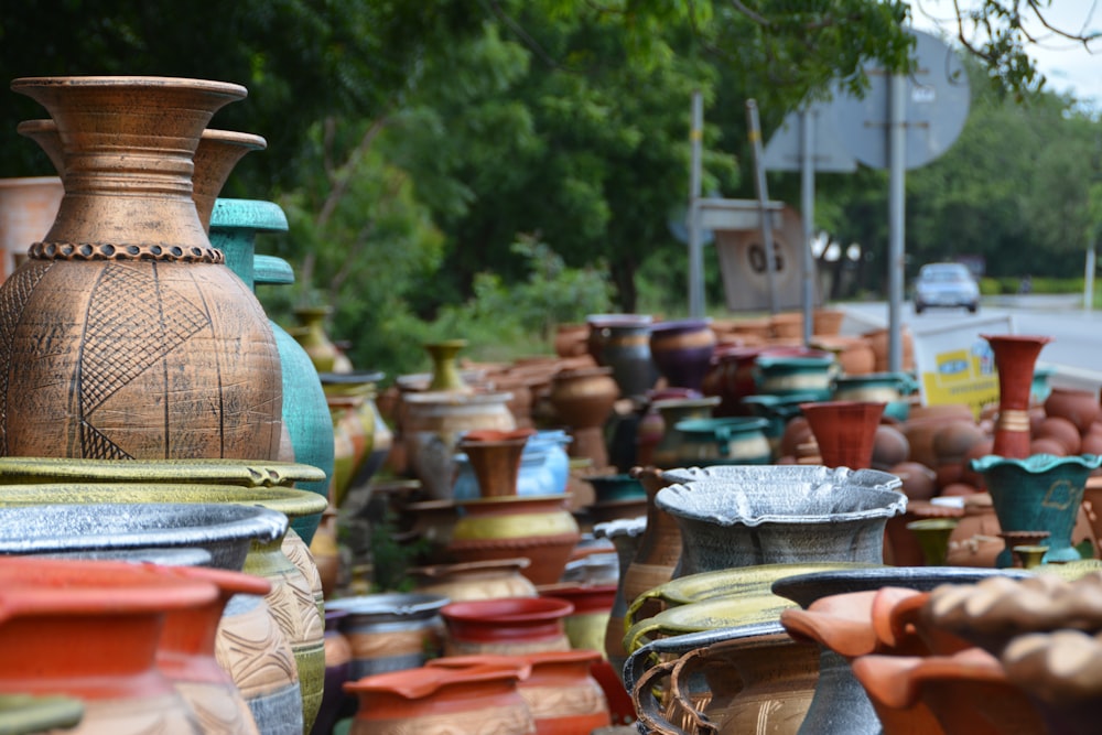 a lot of vases that are sitting on the ground