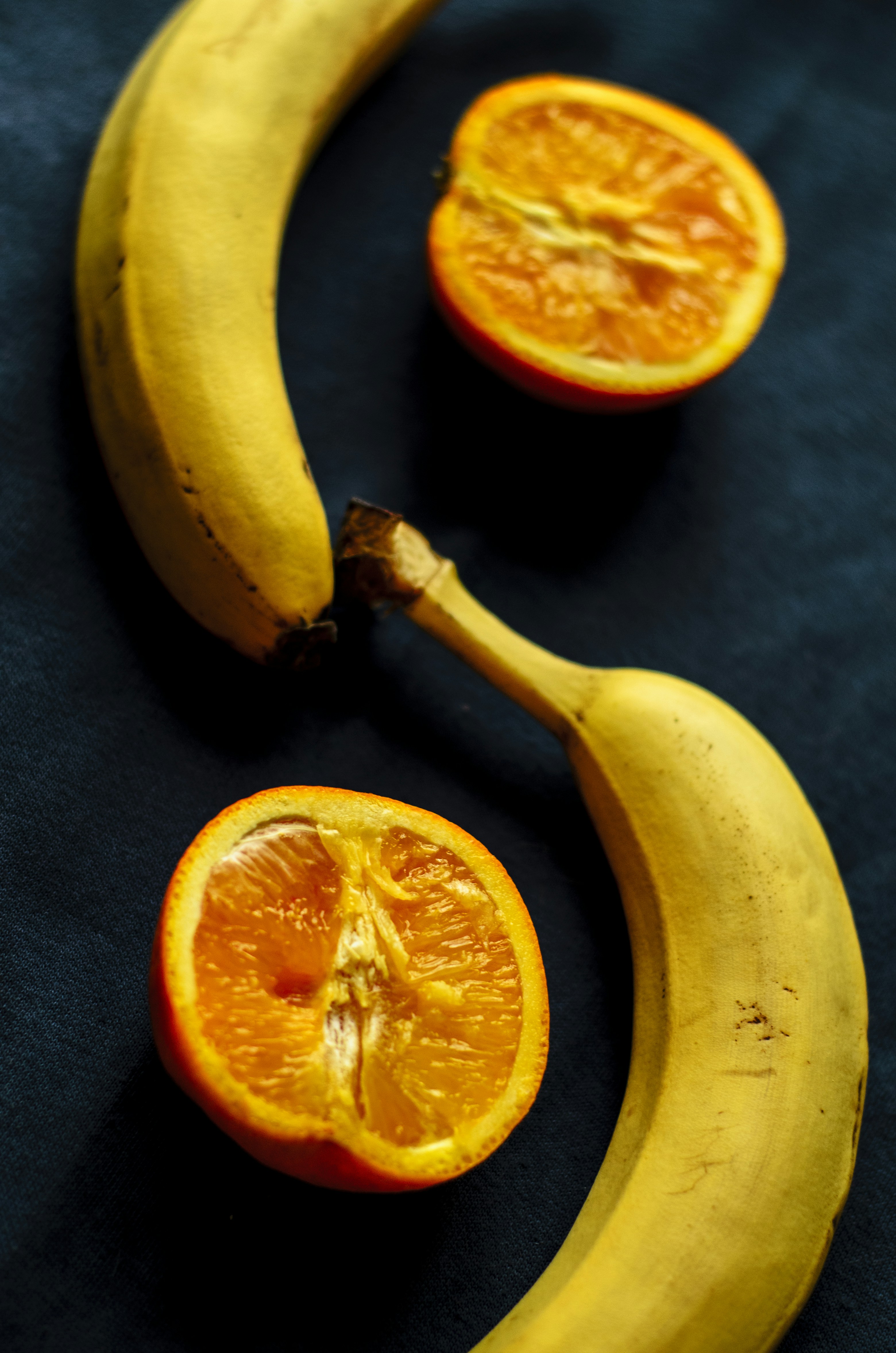 a banana and an orange cut in half