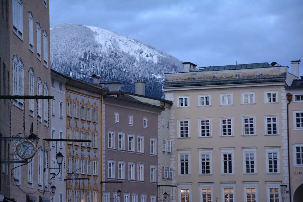 a group of buildings with a mountain in the background