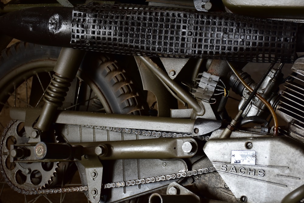 a close up of a motorcycle engine and chain