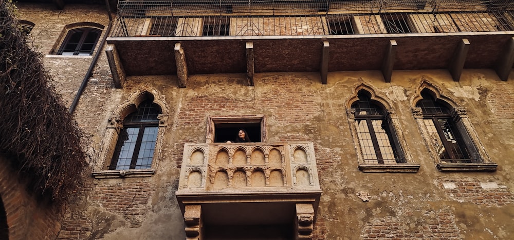 an old building with a balcony and windows